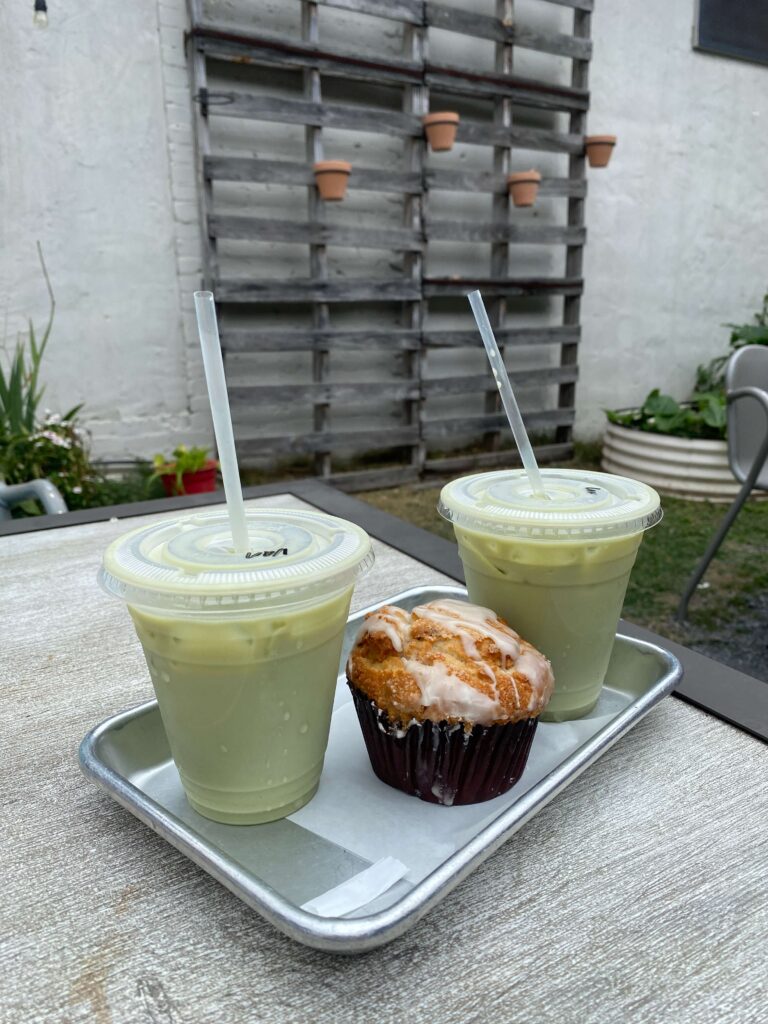 Two matches with a muffin between them on a patio table at Noble & Main Coffee Co