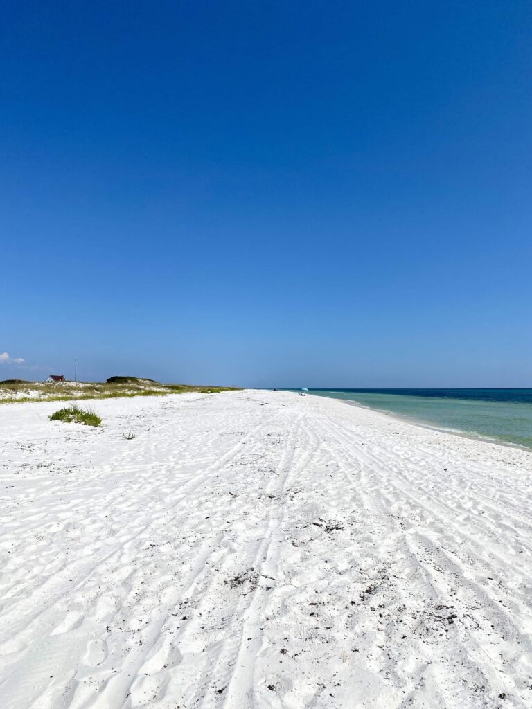 White sand beaches and clear blue skies at the emerald colored beach